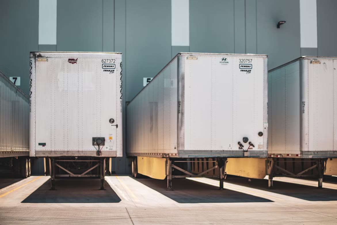Row of trucks and trailers parked at a freight depot